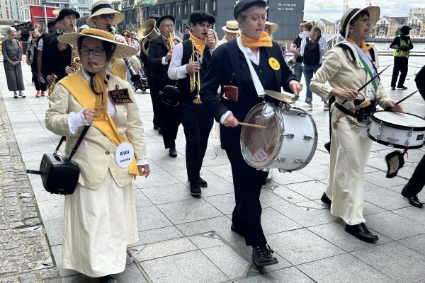 An image of a marching band wearing costumes from the 1920's.