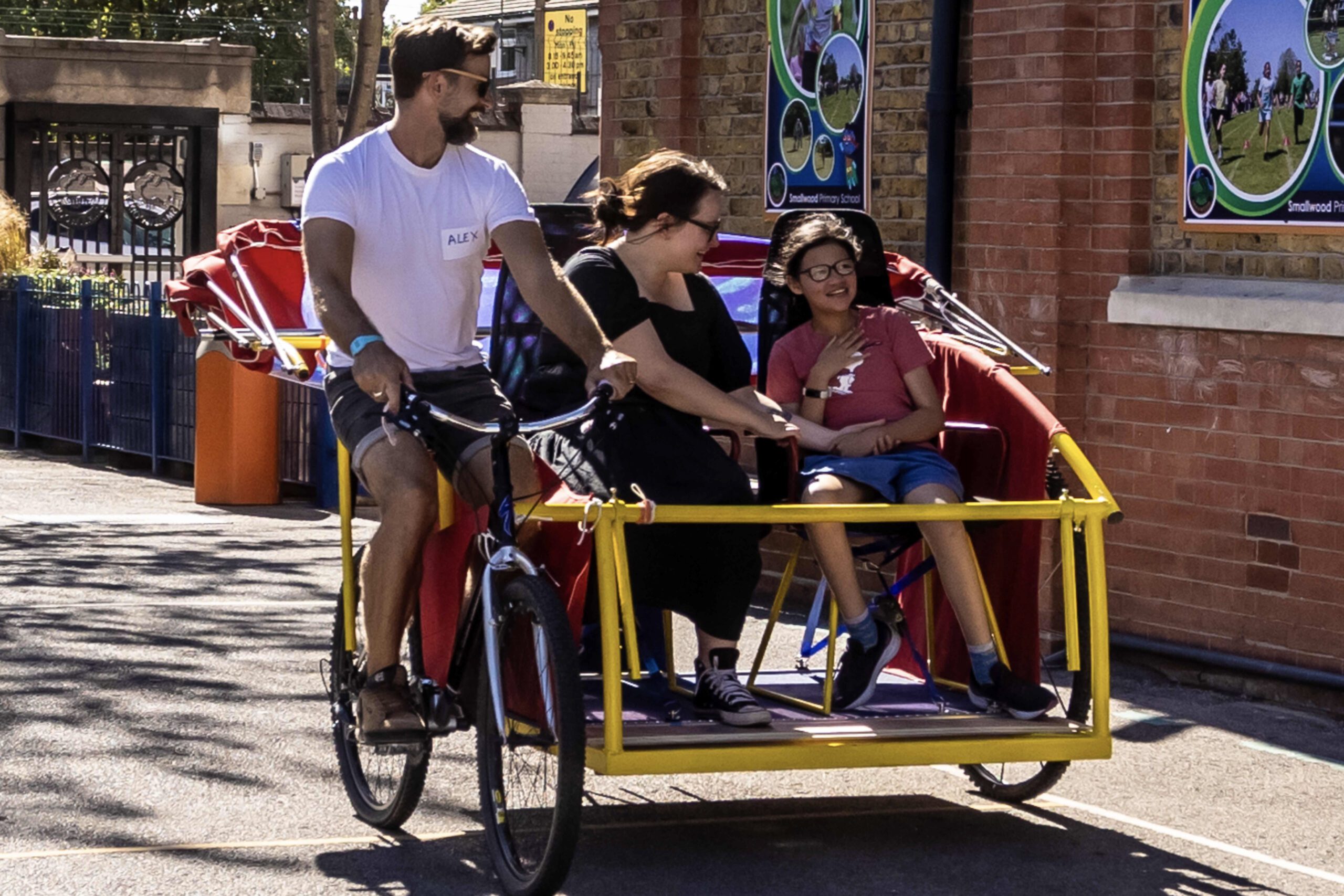 An image of a makeshift tuk-tuk being ridden around with people inside it.