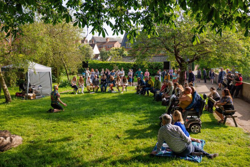 An image of a crowd sat on a field
