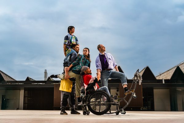 An image of 5 dancers, one a wheelchair user.
