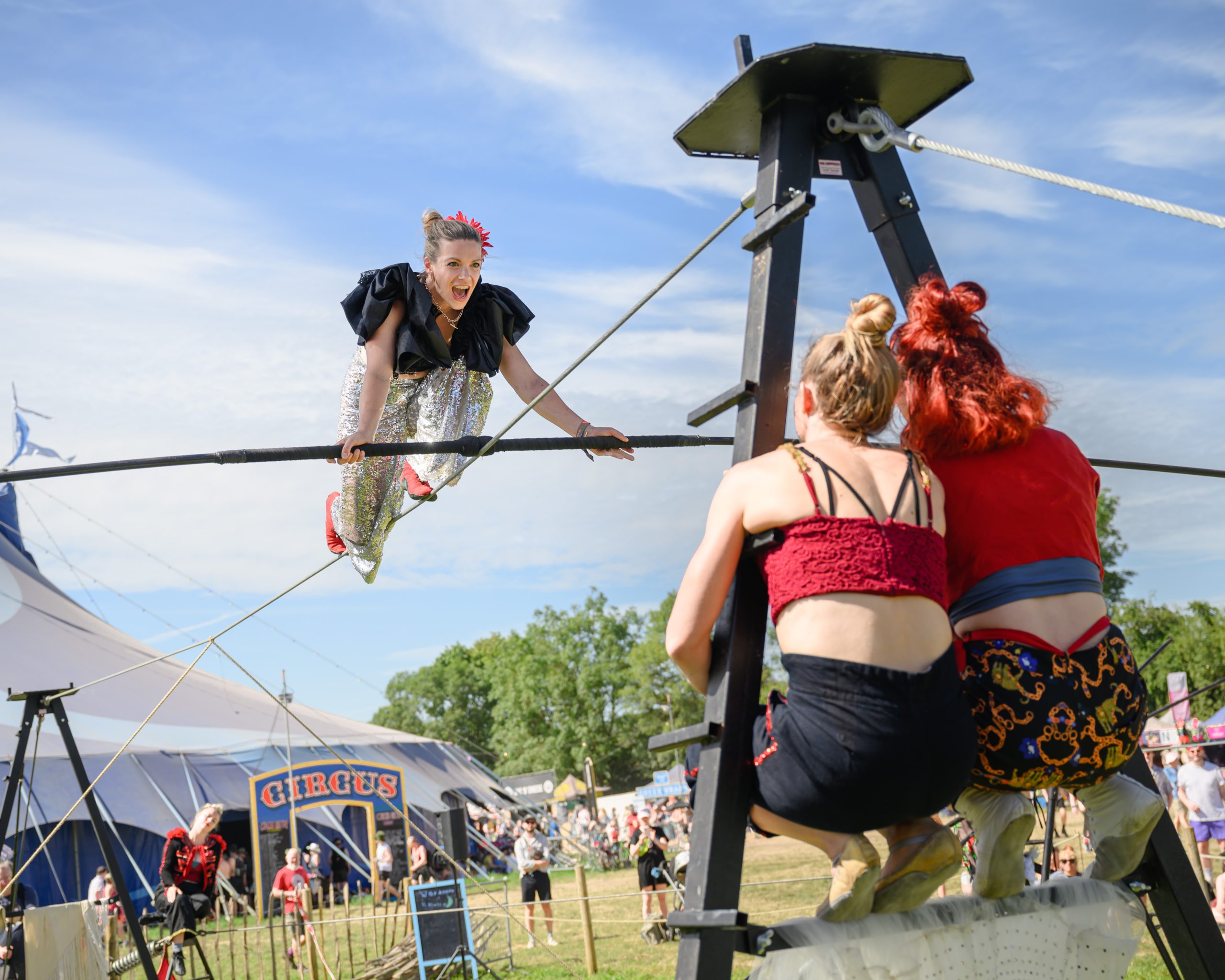 Three female trapeze artists against a blue sky background. The latest news from Without Walls.