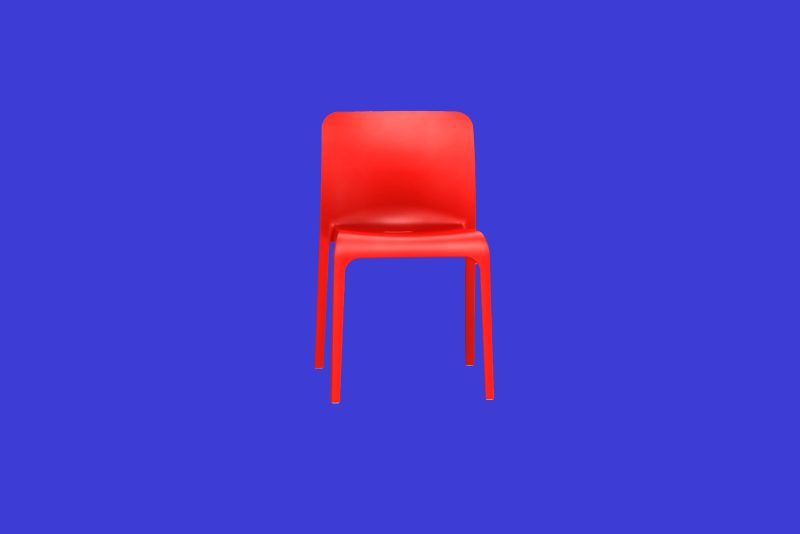 A red chair against a blue background.